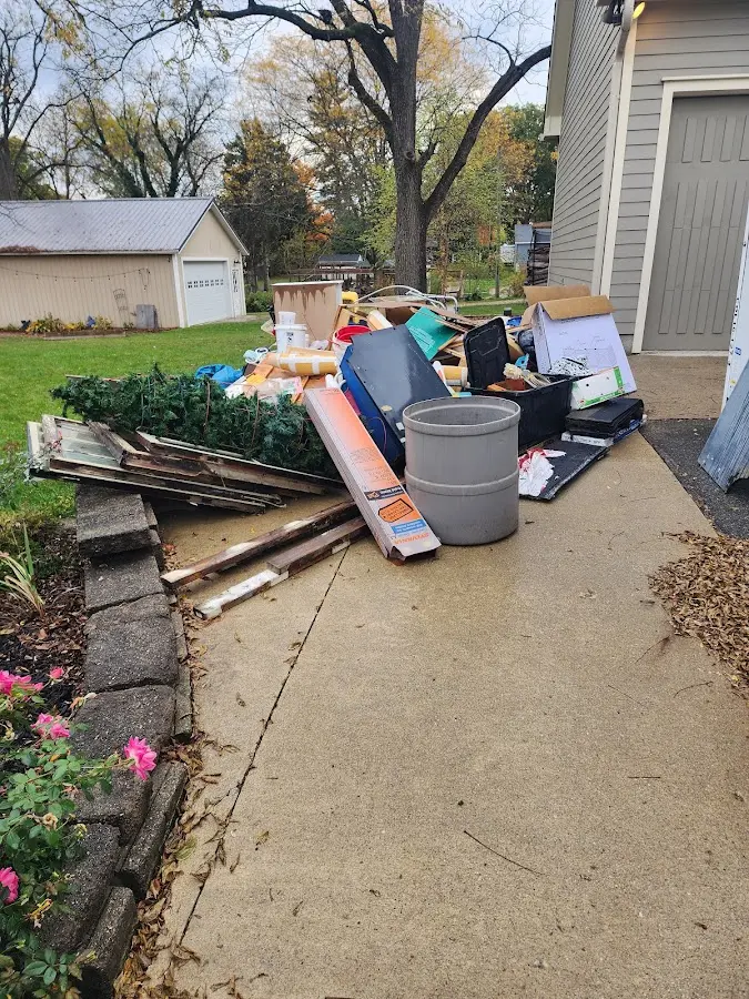 Dumpster being loaded with debris for Demolition Dumpster Rental in Alamo